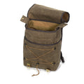 Front and side slip pockets and a tie down area for blankets or jackets all enclosed by the large waxed canvas flap and two leather straps and brass buckles.